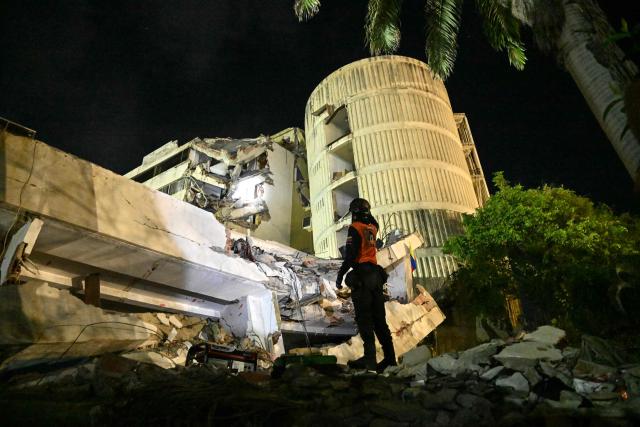 A member of Venezuelan civil defense searches through the rubble of a collapsed building three months after the 7.2 and 7.5-magnitude earthquakes at the Caribbean Residence in Caraballeda, La Guaira state, Venezuela on September 24, 2026. La Guaira is a popular seaside resort 40 km from Caracas that was devastated by the 7.2 and 7.5-magnitude earthquakes that left more than 6,500 dead in Venezuela on June 24, 2026. (Photo by Juan BARRETO / AFP)