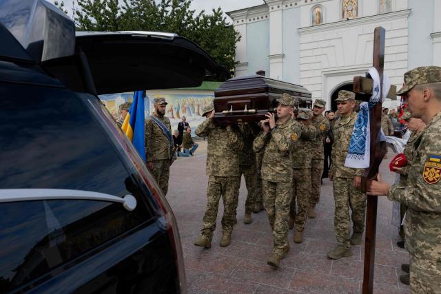 Ukrainian servicemen carry the coffin of Mykola Karpyuk, a Ukrainian serviceman, public and political figure and former political prisoner of the Kremlin who was killed in combat during the Russian invasion of Ukraine, at a funeral ceremony in Kyiv on September 25, 2026. (Photo by Tetiana DZHAFAROVA / AFP)