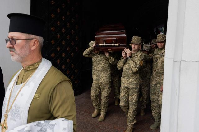 Ukrainian servicemen carry the coffin of Mykola Karpyuk, a Ukrainian serviceman, public and political figure and former political prisoner of the Kremlin who was killed in combat during the Russian invasion of Ukraine, at a funeral ceremony in Kyiv on September 25, 2026. (Photo by Tetiana DZHAFAROVA / AFP)