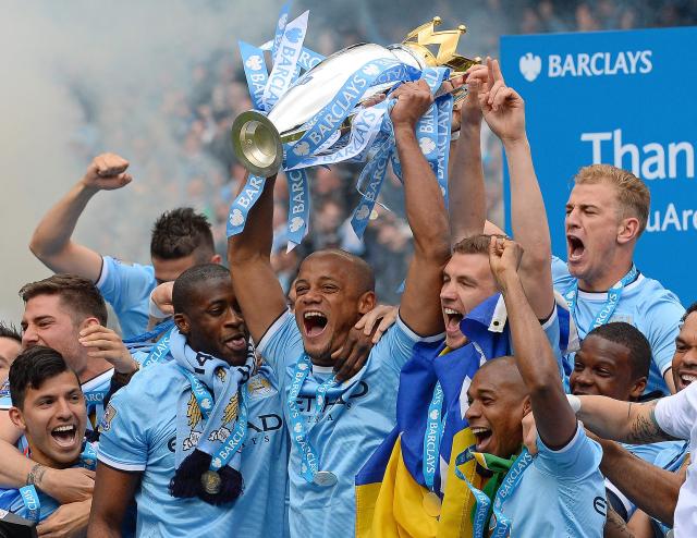 (FILES) Manchester City's Belgian midfielder Vincent Kompany (C) celebrates with the Premiership trophy after his team won 2-0 during the English Premier League football match between Manchester City and West Ham United at the Etihad Stadium in Manchester on May 11, 2014. Manchester City have been found guilty of all but one of 115 Premier League charges they face for breaching financial regulations, the Athletic reported on Friday, September 25, 2026. (Photo by Andrew YATES / AFP)