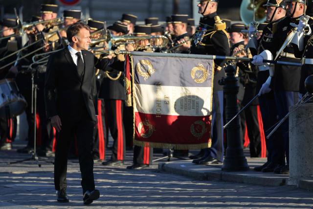French President Emmanuel Macron attends a ceremony to rekindle the flame at the Tomb of the Unknown Soldier at the Arc de Triomphe, and decorate Harkis, members of their families and figures involved in preserving their memory, on the National Day of Tribute to the Harkis and other auxiliary personnel who served alongside the French army during the Algerian War, in Paris, on September 25, 2026. (Photo by Ludovic MARIN / POOL / AFP)