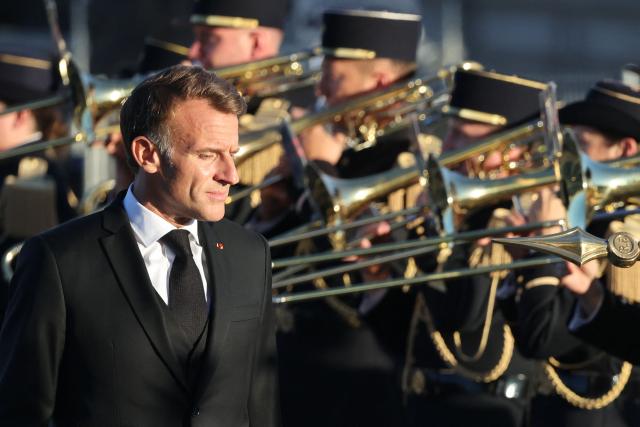 French President Emmanuel Macron attends a ceremony to rekindle the flame at the Tomb of the Unknown Soldier at the Arc de Triomphe, and decorate Harkis, members of their families and figures involved in preserving their memory, on the National Day of Tribute to the Harkis and other auxiliary personnel who served alongside the French army during the Algerian War, in Paris, on September 25, 2026. (Photo by Ludovic MARIN / POOL / AFP)