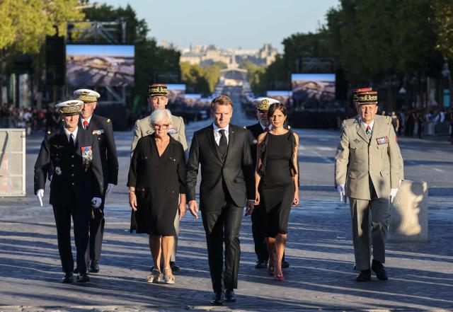 (From L) General Chief of Staff of the French Armed Forces Fabien Mandon, France's Defence Minister Catherine Vautrin, France's President Emmanuel Macron, France's junior Defence Minister Alice Rufo and French Chief of Military staff Vincent Giraud arrive at a ceremony to rekindle the flame at the Tomb of the Unknown Soldier at the Arc de Triomphe, and decorate Harkis, members of their families and figures involved in preserving their memory, on the National Day of Tribute to the Harkis and other auxiliary personnel who served alongside the French army during the Algerian War, in Paris, on September 25, 2026. (Photo by Ludovic MARIN / POOL / AFP)
