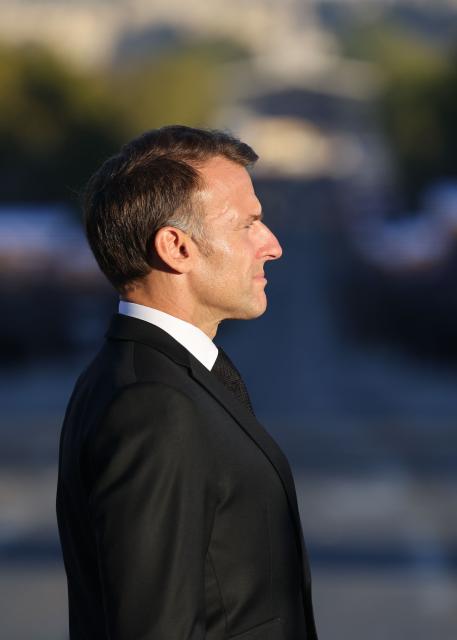 French President Emmanuel Macron attends a ceremony to rekindle the flame at the Tomb of the Unknown Soldier at the Arc de Triomphe, and decorate Harkis, members of their families and figures involved in preserving their memory, on the National Day of Tribute to the Harkis and other auxiliary personnel who served alongside the French army during the Algerian War, in Paris, on September 25, 2026. (Photo by Ludovic MARIN / POOL / AFP)