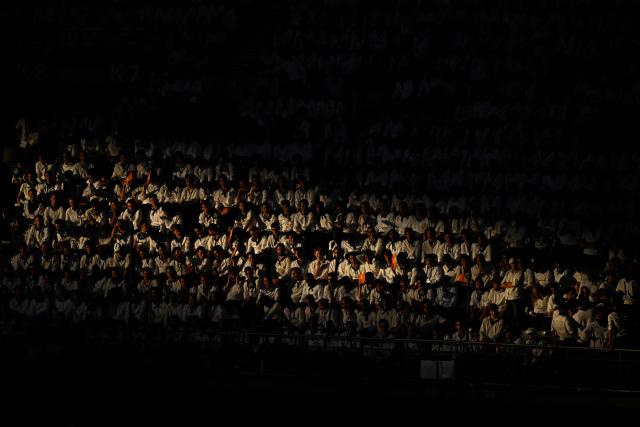 Attendees sit in a tribune prior to the start of a prayer vigil with young people lead by Pope Leo XIV at the Stade de France stadium, in Saint-Denis on the outskirts of Paris on September 25, 2026 as part of his four days visit to France. (Photo by JULIEN DE ROSA / AFP)