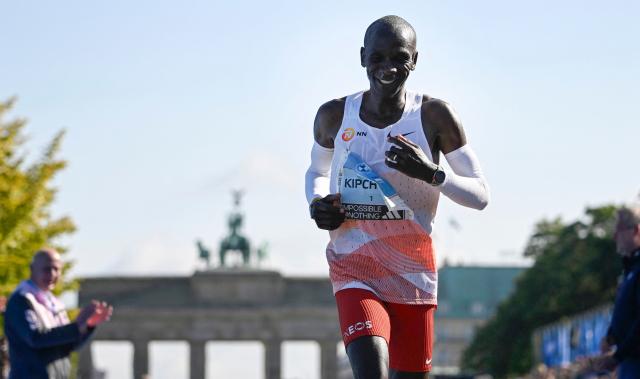 (FILES) Kenya's Eliud Kipchoge crosses the finish line to win the men's race of the Berlin Marathon on September 24, 2023 in Berlin, Germany. Hours after helping Eliud Kipchoge break the marathon world record in Berlin in 2018, bottle carrier Claus-Henning Schulke received a phone call from the Kenyan icon. "He asked me to come to the hotel and he gave me his starting number," the 60-year-old Schulke, better known as 'Bottle Claus', told AFP in Berlin. Schulke helped Kipchoge to four victories in Berlin from 2017 to 2023, including setting the world mark in 2018 and 2022. Kipchoge reserved special praise for Schulke, calling him "still my hero up until now" in 2022. Schulke will be assigned to another contender before the race on September 27, 2026 in one of the most even fields in recent memory. (Photo by Tobias SCHWARZ / AFP)