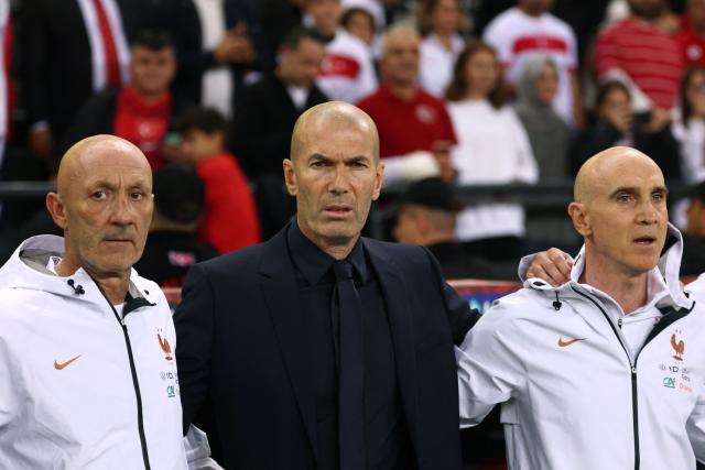 France's head coach Zinedine Zidane, France's goalkeeping coach Fabien Barthez (L) and France's assistant coach David Bettoni (R) look on during the national anthems ahead of the UEFA Nations League (League A, Group 1) first leg football match between Turkey and France at the Kocaeli Stadium in Izmit, on September 25, 2026. (Photo by FRANCK FIFE / AFP)