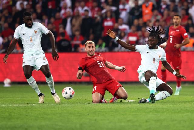 Turkey's forward #21 Baris Alper Yilmaz fights for the ball with France's defender #04 Dayot Upamecano and France's midfielder #08 Manu Kone (R) during the UEFA Nations League (League A, Group 1) first leg football match between Turkey and France at the Kocaeli Stadium in Izmit, on September 25, 2026. (Photo by FRANCK FIFE / AFP)