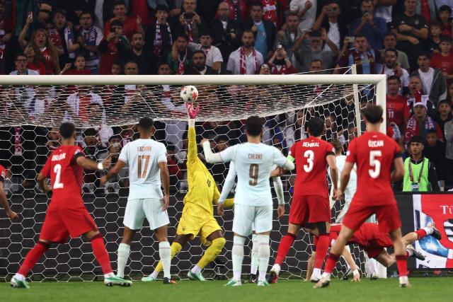 France's goalkeeper #16 Mike Maignan (C) makes a save during the UEFA Nations League (League A, Group 1) first leg football match between Turkey and France at the Kocaeli Stadium in Izmit, on September 25, 2026. (Photo by FRANCK FIFE / AFP)