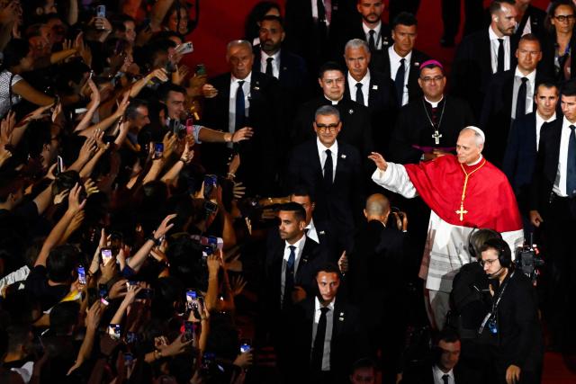 Pope Leo XIV waves to the crowd as he leaves at the end of a prayer vigil with young people at the Stade de France stadium, in Saint-Denis on the outskirts of Paris on September 25, 2026 as part of his four days visit to France. (Photo by JULIEN DE ROSA / AFP)