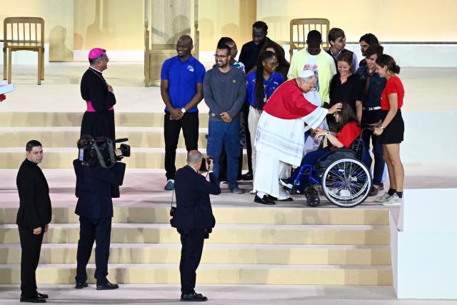 Pope Leo XIV blesses a youth on a wheelchair at the end of a prayer vigil with young people at the Stade de France stadium, in Saint-Denis on the outskirts of Paris on September 25, 2026 as part of his four days visit to France. (Photo by JULIEN DE ROSA / AFP)