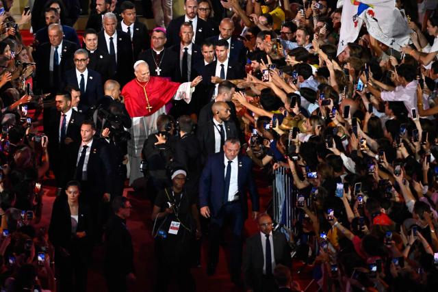 Pope Leo XIV waves to the crowd as he leaves at the end of a prayer vigil with young people at the Stade de France stadium, in Saint-Denis on the outskirts of Paris on September 25, 2026 as part of his four days visit to France. (Photo by JULIEN DE ROSA / AFP)