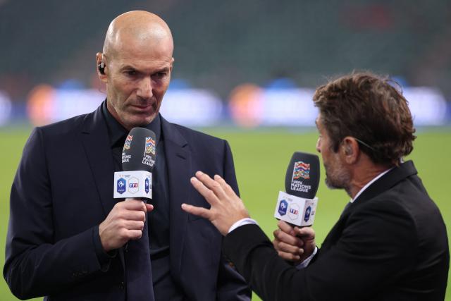 France's head coach Zinedine Zidane (L) gives an interview to former France football international and sports commentator Bixente Lizarazu after his first match as France manager following the UEFA Nations League (League A, Group 1) first leg football match between Turkey and France at the Kocaeli Stadium in Izmit, on September 25, 2026. (Photo by FRANCK FIFE / AFP)