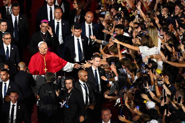 Pope Leo XIV greets the crowd as he leaves at the end of a prayer vigil with young people at the Stade de France stadium, in Saint-Denis on the outskirts of Paris on September 25, 2026 as part of his four days visit to France. (Photo by JULIEN DE ROSA / AFP)
