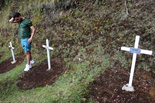 A Chapecoense's player visits the Chapecoense plane crash's memorial ahead of the 10th anniversary of the accident on Mt. Cerro Gordo, near La Union, Antioquia department, Colombia, on September 25, 2026. On November 28, 2016 the plane flying Chapecoense to Medellin to take on Atletico Nacional in the Copa Sudamericana finals -the biggest and most unexpected game in the Brazilian team's history- ran out of fuel and went down in the mountains near its destination, killing 71 of the 77 aboard, including 19 players. (Photo by Jaime SALDARRIAGA / AFP)