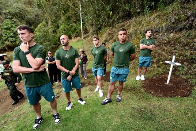 Chapecoense's players visit the Chapecoense plane crash's memorial ahead of the 10th anniversary of the accident on Mt. Cerro Gordo, near La Union, Antioquia department, Colombia, on September 25, 2026. On November 28, 2016 the plane flying Chapecoense to Medellin to take on Atletico Nacional in the Copa Sudamericana finals -the biggest and most unexpected game in the Brazilian team's history- ran out of fuel and went down in the mountains near its destination, killing 71 of the 77 aboard, including 19 players. (Photo by Jaime SALDARRIAGA / AFP)