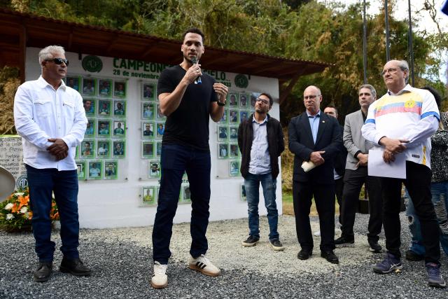 Former Brazilian football player Helio Neto speaks as a survivor during a visit to the Chapecoense plane crash's memorial ahead of the 10th anniversary of the accident on Mt. Cerro Gordo, near La Union, Antioquia department, Colombia, on September 25, 2026. On November 28, 2016 the plane flying Chapecoense to Medellin to take on Atletico Nacional in the Copa Sudamericana finals -the biggest and most unexpected game in the Brazilian team's history- ran out of fuel and went down in the mountains near its destination, killing 71 of the 77 aboard, including 19 players. (Photo by Jaime SALDARRIAGA / AFP)