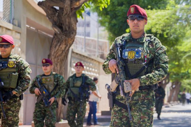 Colombian soldiers patrol the streets as Colombia's President Abelardo de la Espriella attends a security council meeting in Santa Marta, Colombia on September 25, 2026. Hundreds of soldiers and police officers patrol the streets of the tourist city of Santa Marta, Colombia, on September 25, 2026, following operations against a drug trafficking gang that triggered a wave of attacks, forced businesses to close and left the streets deserted. (Photo by Marco PERDOMO / AFP)