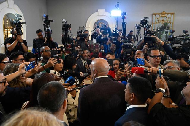 Venezuela's National Assembly President Jorge Rodriguez (C) speaks to journalists following the signing of an agreement between government and opposition delegations at the closing of the second round of political dialogue talks at the Melia hotel in Caracas on September 25, 2026. (Photo by Federico PARRA / AFP)