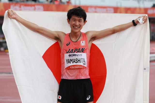 Japan's Ichitaka Yamashita celebrates after winning gold in the men's marathon final during the 2026 Asian Games at Nagoya City Mizuho Park Athletic Stadium in Nagoya, Aichi Prefecture on September 26, 2026. (Photo by DAVID GRAY / AFP)