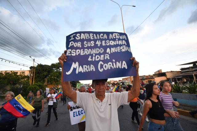 A demonstrator holds a sign during a march demanding the return of Venezuelan opposition leader María Corina Machado to Venezuela, in Valencia, Venezuela, on September 25, 2026. (Photo by Jacinto OLIVEROS / AFP)