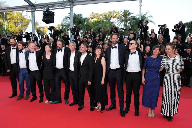 (FILES) French actor Swann Arlaud (C-L) and French director and screenwriter Emmanuel Marre (C-R) pose with cast members of the film "Notre Salut" (A Man of His Time) on the red carpet ahead of the closing ceremony of the 79th edition of the Cannes Film Festival in Cannes, southern France, on May 23, 2026. “Notre salut,” which opens in theaters in France on September 30, 2026, chronicles the life of Henri Marre (played by Swann Arlaud), a low-ranking civil servant working at the office for combating unemployment, who attempted to advance his career within the Vichy administration. (Photo by Thibaud MORITZ / AFP)