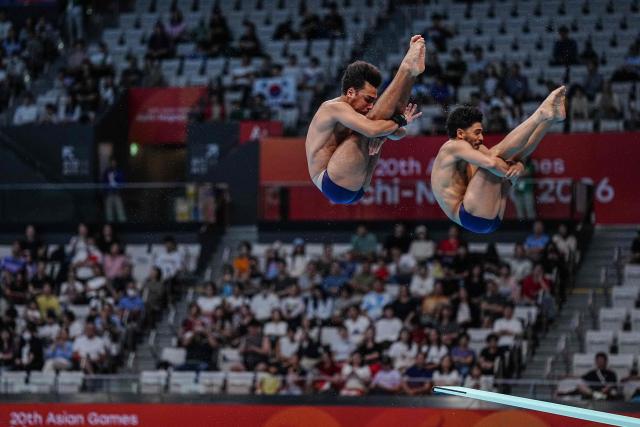 Iran's diver Sam Vajerhelabad and Iran's diver Seyedmohammad Moghadasi compete in the men's synchronised 3m springboard final diving event during the 2026 Asian Games at the Tokyo Aquatics Centre in Tokyo on September 26, 2026. (Photo by Yuichi YAMAZAKI / AFP)
