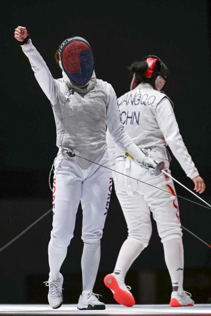 South Korea's Mo Byeo-li (L) celebrates a point against China's Huang Qianqian in the women's foil team semi-final fencing event in the 2026 Asian Games at Aichi Sky Expo in Aichi Prefecture on September 26, 2026 (Photo by MOHD RASFAN / AFP)