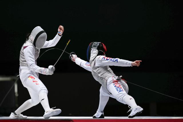 South Korea's Sim So-eun (R) scores a point against China's Zhang Siqi in the women's foil team semi-final fencing event in the 2026 Asian Games at Aichi Sky Expo in Aichi Prefecture on September 26, 2026 (Photo by MOHD RASFAN / AFP)