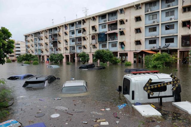 Flood waters submerge cars next to residential buildings after heavy rain in Bangkok on September 26, 2026. Bangkok authorities declared a flood disaster across the Thai capital on September 26 after almost 48 hours of heavy rain left canals full, roads submerged and residents knee-deep in water. (Photo by Sarot Meksophawannakul / THAI NEWS PIX / AFP)