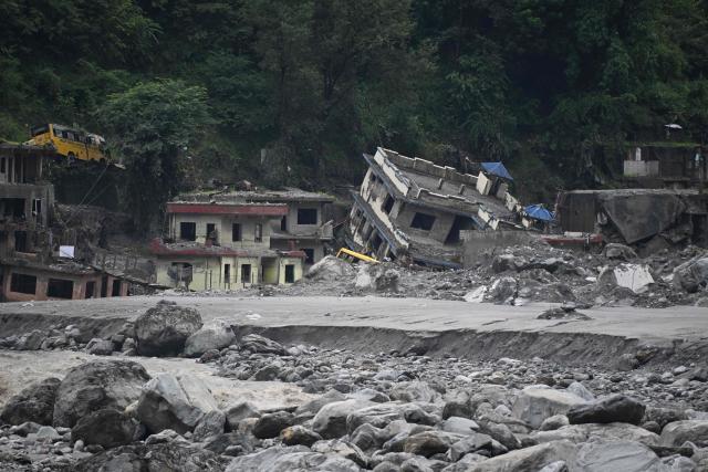 A general view shows damaged houses covered in sludge in the aftermath of the August 26 flash flood at Betrawoti Bazaar in Nepal’s Rasuwa district on September 26, 2026. The August 26 flood, triggered by a glacial mountain collapse near the China-Nepal border, has killed more than 1,400 people, the majority in Nepal. Over 5,000 remain missing in Nepal since the tsunami-like waves swept away roads, bridges and settlements in the mountainous regions up north, and battered crucial hydropower projects. (Photo by PRAKASH MATHEMA / AFP)