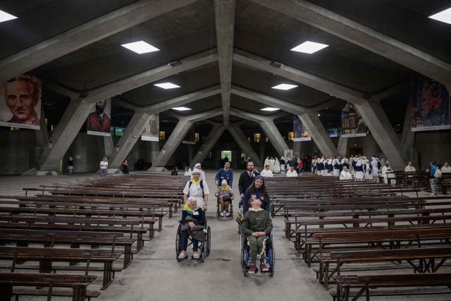 Worshippers gather for a mass at the basilique Saint Pie, in Lourdes on September 26, 2026. (Photo by Ed JONES / AFP)