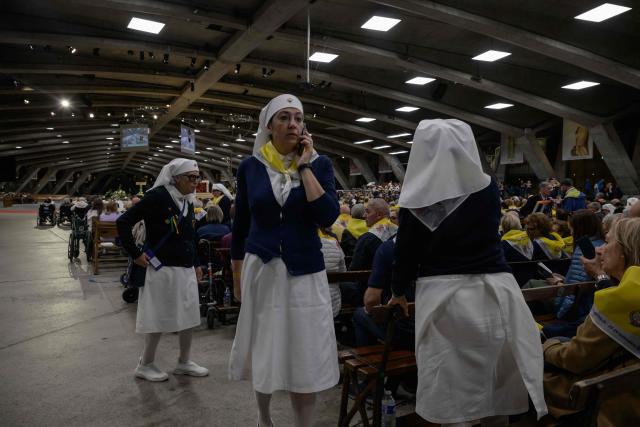 Worshippers gather for a mass at the basilique Saint Pie, in Lourdes on September 26, 2026. (Photo by Ed JONES / AFP)