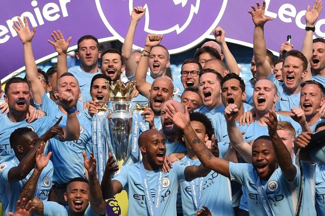 (FILES) Manchester City's Belgian midfielder Vincent Kompany (C) celebrates with the Premiership trophy after his team won 2-0 during the English Premier League football match between Manchester City and West Ham United at the Etihad Stadium in Manchester on May 11, 2014. Manchester City have been found guilty of all but one of 115 Premier League charges they face for breaching financial regulations, the Athletic reported on Friday, September 25, 2026. (Photo by Oli SCARFF / AFP)