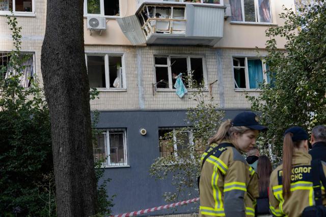 A man cleans broken glass from a window of his damaged balcony following a drone strike in Kyiv on September 26, 2026, amid the Russian invasion of Ukraine. Russian strikes on Kyiv during the day killed seven people on September 25, 2026, including a 14-year-old boy, local authorities said, as Ukraine's leader disclosed that US President had approved licences for Patriot air-defence systems. (Photo by Tetiana DZHAFAROVA / AFP)