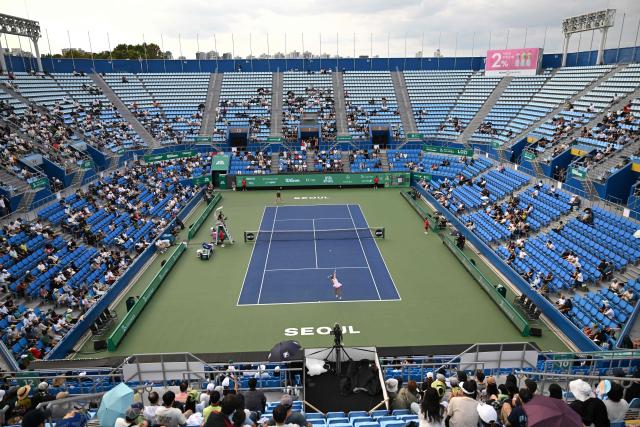 Anna Bondar of Hungary (bottom) serves against Kimberly Birrell of Australia (top) during their women’s singles semi-final match at the Korea Open tennis championships in Seoul on September 26, 2026. (Photo by Jung Yeon-je / AFP)