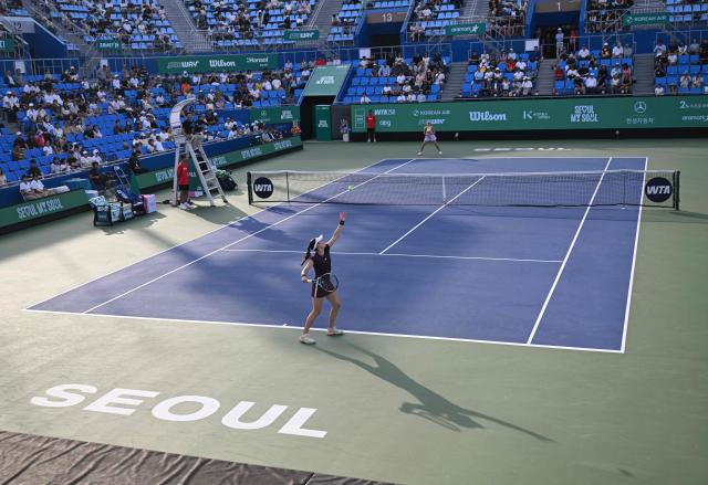 Kimberly Birrell of Australia (front) serves against Anna Bondar of Hungary (rear) during their women’s singles semi-final match at the Korea Open tennis championships in Seoul on September 26, 2026. (Photo by Jung Yeon-je / AFP)