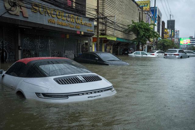Cars are submerged in flood waters after heavy rain in Bangkok on September 26, 2026. Bangkok authorities declared a flood disaster across the Thai capital on September 26 after almost 48 hours of heavy rain left canals full, roads submerged and residents knee-deep in water. (Photo by Arnun Chonmahatrakool / THAI NEWS PIX / AFP)
