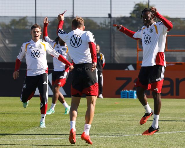 (L-R) Germany's Florian Wirtz, Joshua Kimmich and Yann Aurel Bisseck warm up during a training session of Germany's national football team in Herzogenaurach, southern Germany on September 26, 2026, ahead of their UEFA Nations League football match against Greece on September 27. (Photo by ALEXANDRA BEIER / AFP)
