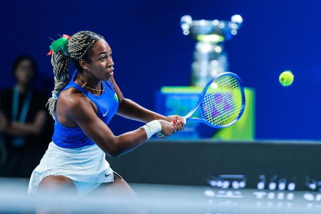 Italy’s Tyra Grant hits a return to Ukraine’s Anhelina Kalinina during their women’s singles semi-final match at the Billie Jean King Cup tennis tournament in Shenzhen, in China’s southern Guangdong province on September 26, 2026. (Photo by CN-STR / AFP) / China OUT
