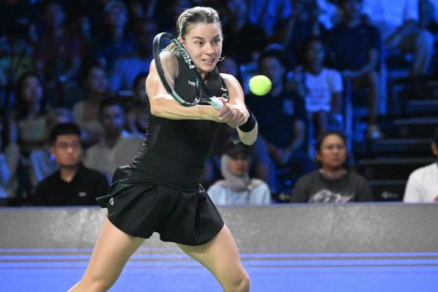 Poland's Maja Chwalinska hits a return against Canada's Leylah Fernandez during the WTA Singapore Open Tennis semifinal in Singapore on September 26, 2026. (Photo by Roslan RAHMAN / AFP)