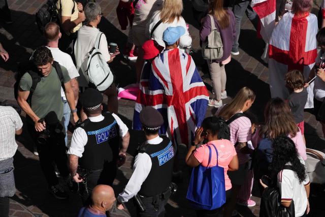 Police wander through a crowd of protesters gathering on the Victoria Embankment with Union flags ahead of a march organised by togetherforthechildren in central London on September 26, 2026. (Photo by CARLOS JASSO / AFP)