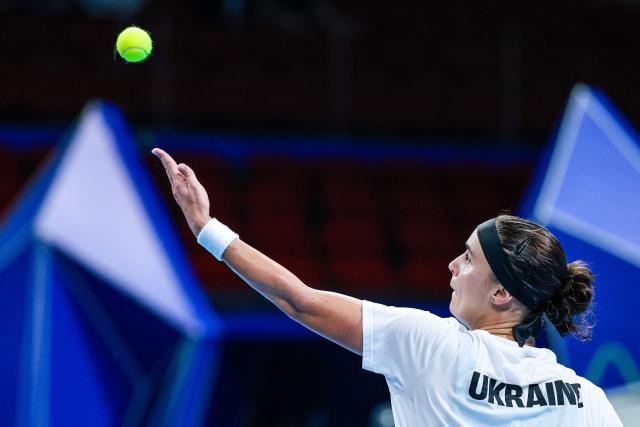 Ukraine’s Anhelina Kalinina serves to Italy’s Tyra Grant during their women’s singles semi-final match at the Billie Jean King Cup tennis tournament in Shenzhen, in China’s southern Guangdong province on September 26, 2026. (Photo by CN-STR / AFP) / China OUT