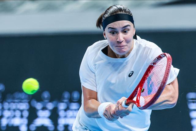 Ukraine’s Anhelina Kalinina hits a return to Italy’s Tyra Grant during their women’s singles semi-final match at the Billie Jean King Cup tennis tournament in Shenzhen, in China’s southern Guangdong province on September 26, 2026. (Photo by CN-STR / AFP) / China OUT