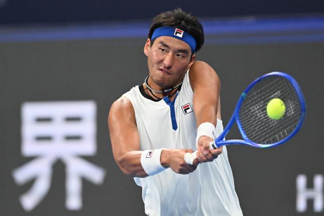 China’s Bu Yunchaokete hits a return to Poland’s Kamil Majchrzak during their men’s singles match at the Hangzhou Open tennis tournament in Hangzhou, in China’s eastern Zhejiang province on September 26, 2026. (Photo by AFP) / China OUT