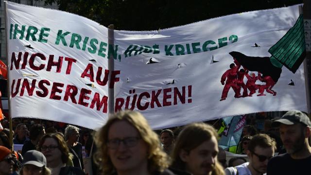 Demonstrators display a banner during a protest against health insurance and pension reforms organised by the German Trade Union Confederation (DGB), attended by leaders of The Left party (Die Linke), in Berlin on September 26, 2026. (Photo by John MACDOUGALL / AFP)
