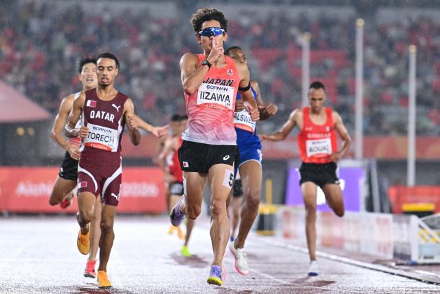 Japan's Kazuto Iizawa (C) reacts after crossing the finish line in the men's 1500m heat during the 2026 Asian Games at Nagoya City Mizuho Park Athletic Stadium in Nagoya, Aichi Prefecture on September 26, 2026. (Photo by MOHD RASFAN / AFP)