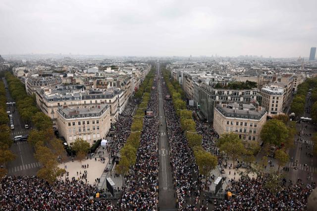 A photograph taken from the roof of the Arc de Triomphe shows worshippers gathered along the Champs-Elysees Avenue to attend a solemn outdoor mass celebrated by Pope Leo XIV at Place de la Concorde, central Paris, on September 26, 2026 on the second day of his visit to France. Pope Leo XIV celebrates an open-air mass for hundreds of thousands of believers on the Champs Elysees in Paris, after saying it was possible to "live together in dignity and peace". (Photo by Sameer AL-DOUMY / AFP)
