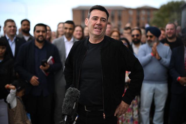 Britain's Prime Minister Andy Burnham speaks to supporters after arriving at the annual Labour Party conference in Liverpool, north-west England, on September 26, 2026. Britain's ruling Labour Party gathers Sunday for its first annual conference under Andy Burnham's leadership, heartened by his start as prime minister but now looking for concrete plans to tackle looming challenges. (Photo by Oli SCARFF / AFP)