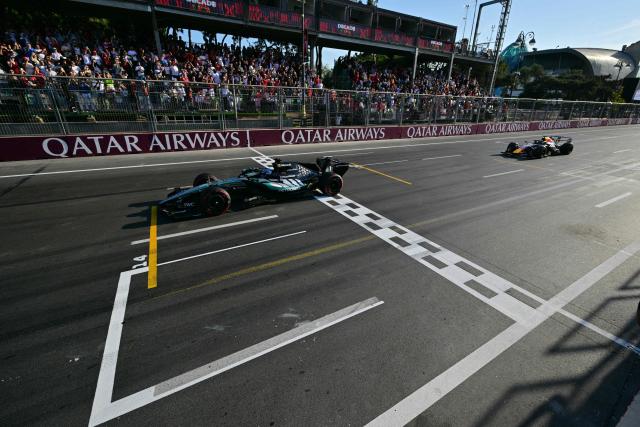 TOPSHOT - Mercedes' British driver George Russell wins ahead of Red Bull Racing's Dutch driver Max Verstappen in the Formula One Azerbaijan Grand Prix at the Baku City Circuit in Baku on September 26, 2026. (Photo by Andrej ISAKOVIC / POOL / AFP)